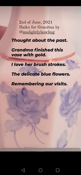 White porcelain vase in closeup, has blue roses and a gold line painted on it. The poem goes: Thought about the past - Grandma finished this vase with gold. I love her brushstrokes. The delicate blue flowers. Remembering our visits. 